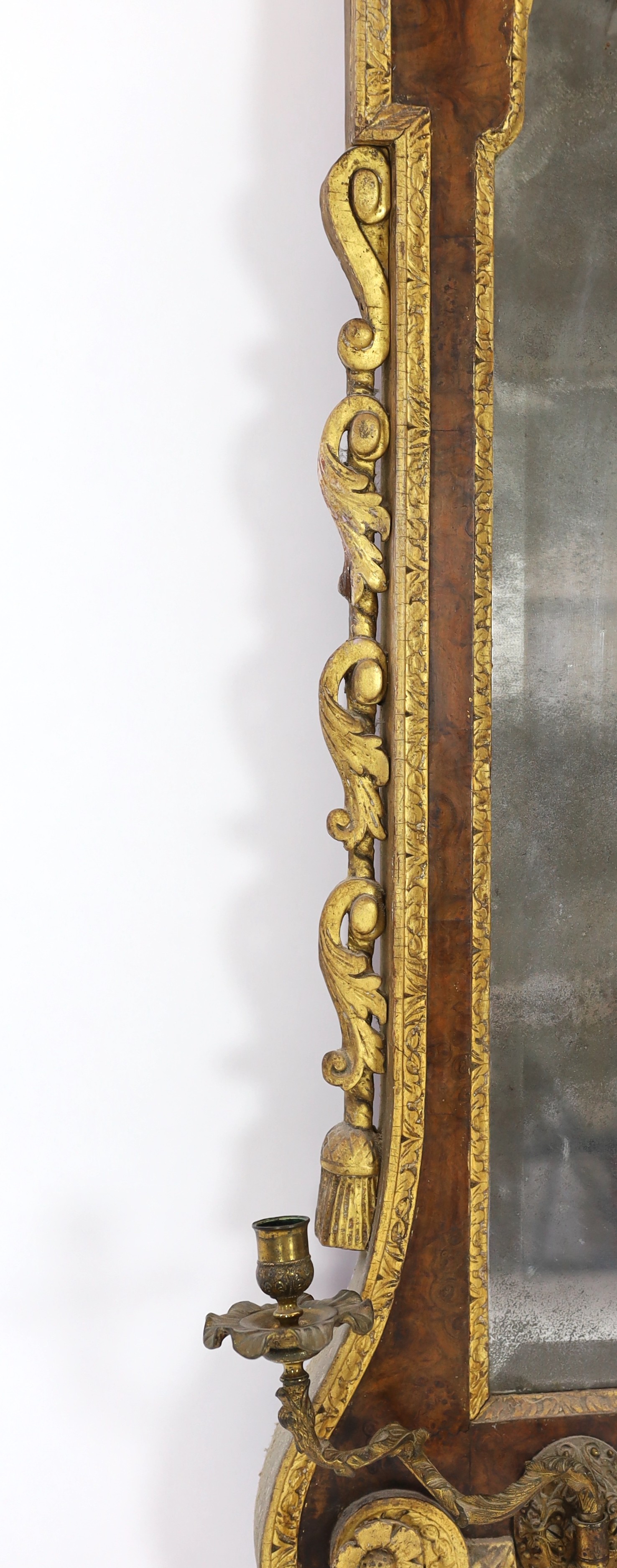 A George II and later carved giltwood and burr walnut wall mirror, 133.5cm high, 69cm wide